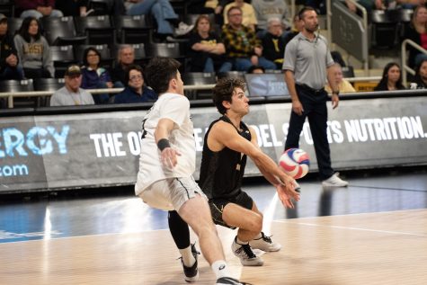 Long Beach State men's volleyball senior libero Mason Briggs (right) goes for a reception off of a Lewis' serve in their matchup inside the Walter Pyramid. The Beach would beat the Flyers 3-1 as Briggs would record 15 digs on the night.