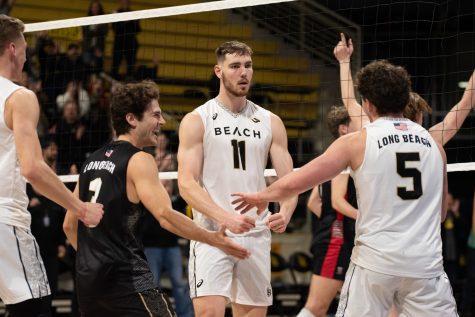 Long Beach State men's volleyball senior middle blocker Simon Torwie (white #11) celebrates scoring the game-winning point against Lewis inside the Walter Pyramid. Torwie would record 13 kills on 16 attempts to help lead the Beach to the 3-1 victory over the Flyers.