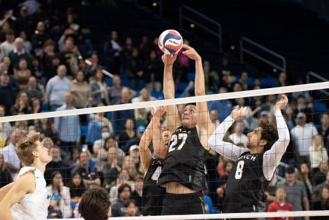 02/10/2024 - Los Angeles, CALIF: Long Beach State men's volleyball freshman middleblocker Lazar Bouchkov (black #27) blocks a kill attempt against UCLA at the Pauley Pavilion. Bouchkov would end the game with three block assists and six kills as the Beach fell to the Bruins 3-1.