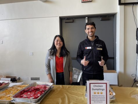 02/12/24 - Michelle Chang (left), Director, Academic Internships Office and Forrest Alvarez (right), Assistant Program Coordinator for Multicultural Affairs volunteered to serve food, chicken dumplings, for students who attended the Lunar New Year event in the USU Ballroom.