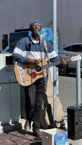2/10/24 - Performer Dion Lovelle singing and playing guitar for Belmont Shore Chocolate Fest attendees to enjoy.