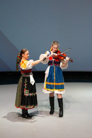 3/23/2024 - Anna Hradsky (Left) assists Natasha Braden (right) as she performs a traditional Slavic song through vocals and the violin.
