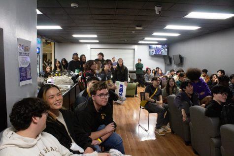 3/9/24 LONG BEACH, CALIF.: Students from both Long Beach State and the University of California, Riverside watch in suspense during one of the maps of Overwatch 2, one of the closest games played of the day. The cheers and screams from the audiences could be heard in gaming room behind them, which was closed to keep the competitors focus on the task at hand.