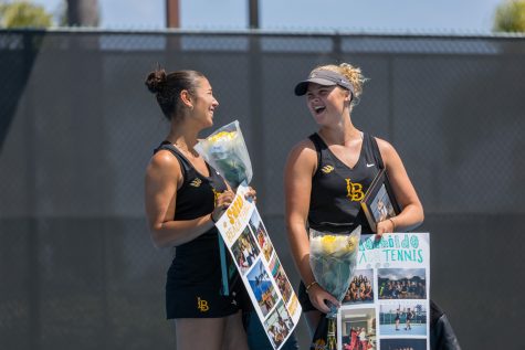 Seniors Sarah Medik and Mathilde Tranberg share a laugh during their senior recognition game against UC Irvine. All four of LBSU's graduating tennis team came in as sophomore transfers.